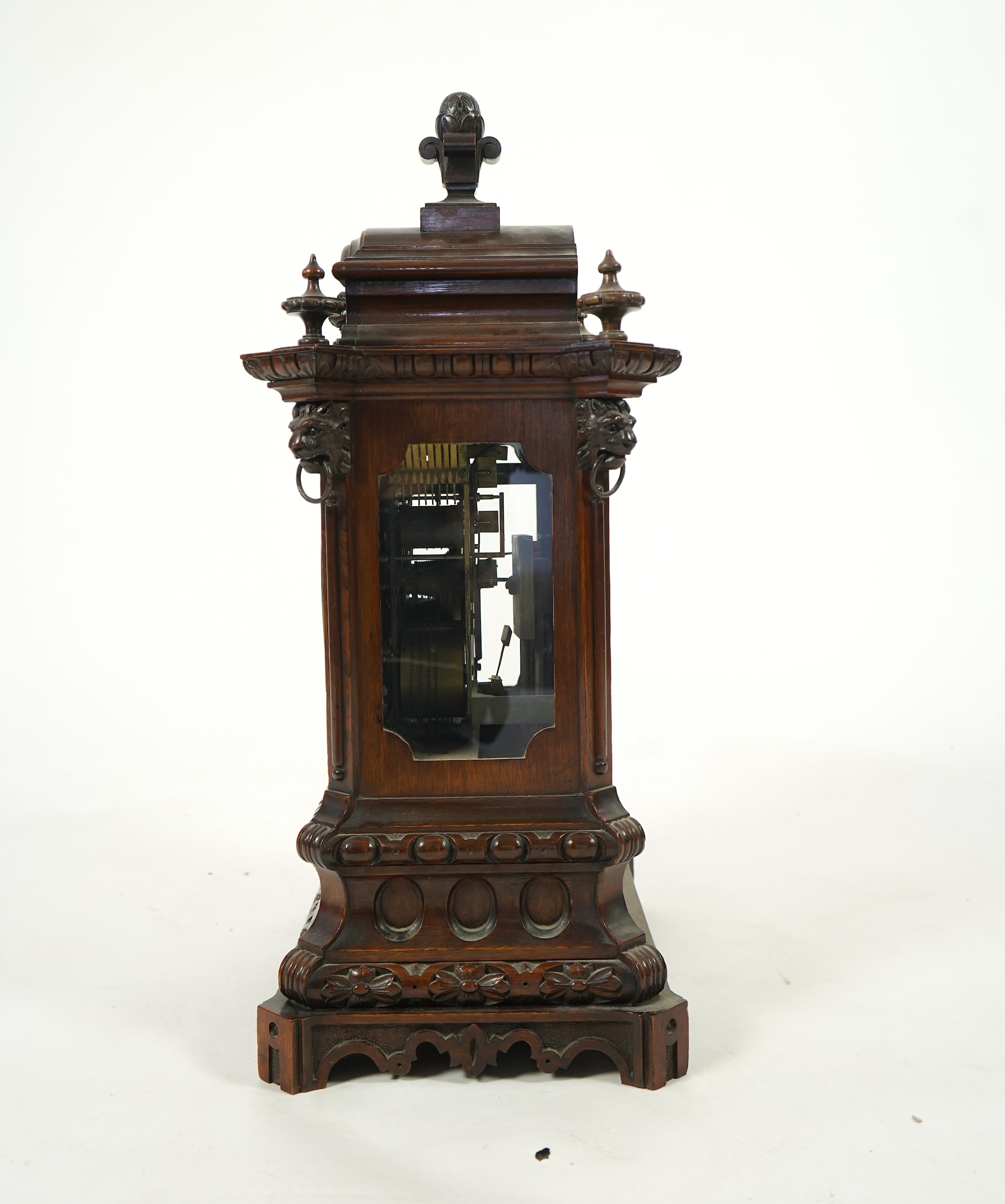 A late 19th century carved oak triple fusee bracket clock